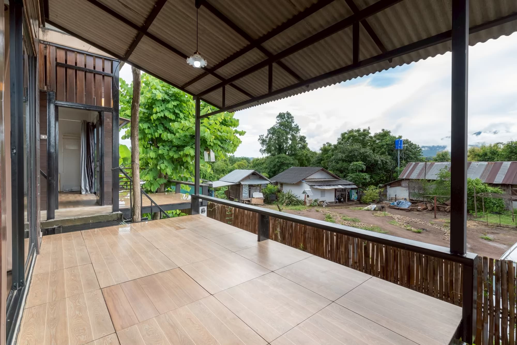 365 Vila Connect Pai rooftop terrace with hanging lantern, timber gable and open mountain view over the village