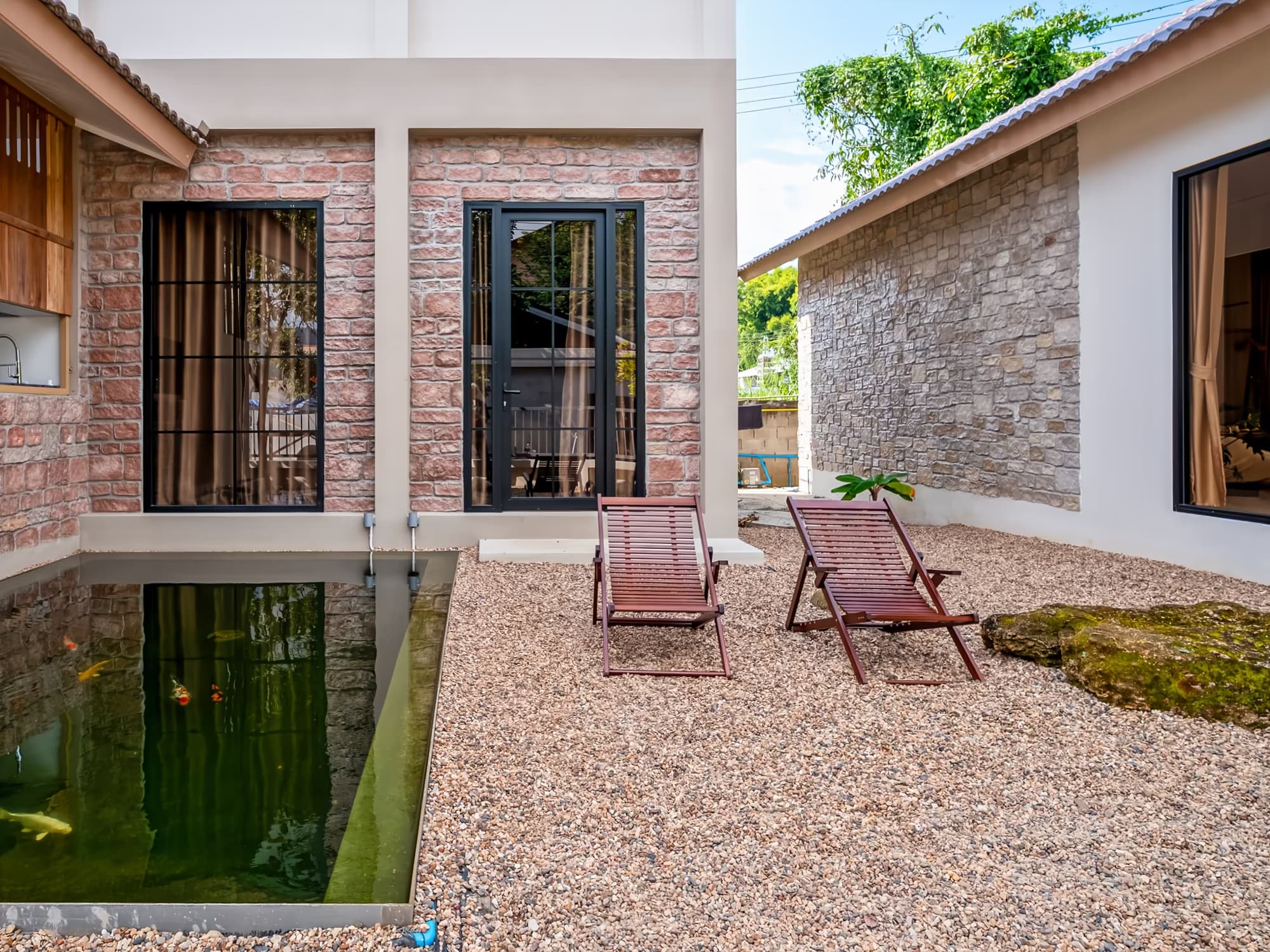 The Arch Casa design hotel Pai stone-clad villa with reflecting plunge pond and lounge chairs