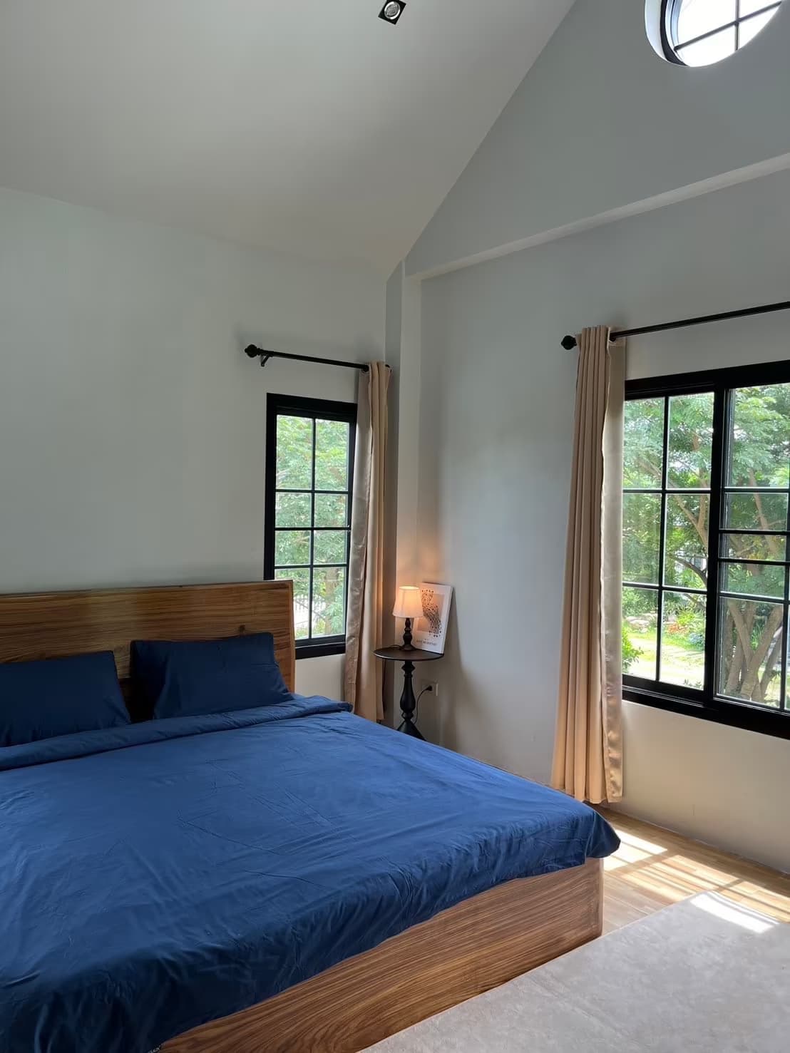 Eden Villa, Pai - airy master bedroom with vaulted ceiling, blue king bed and twin garden-view windows