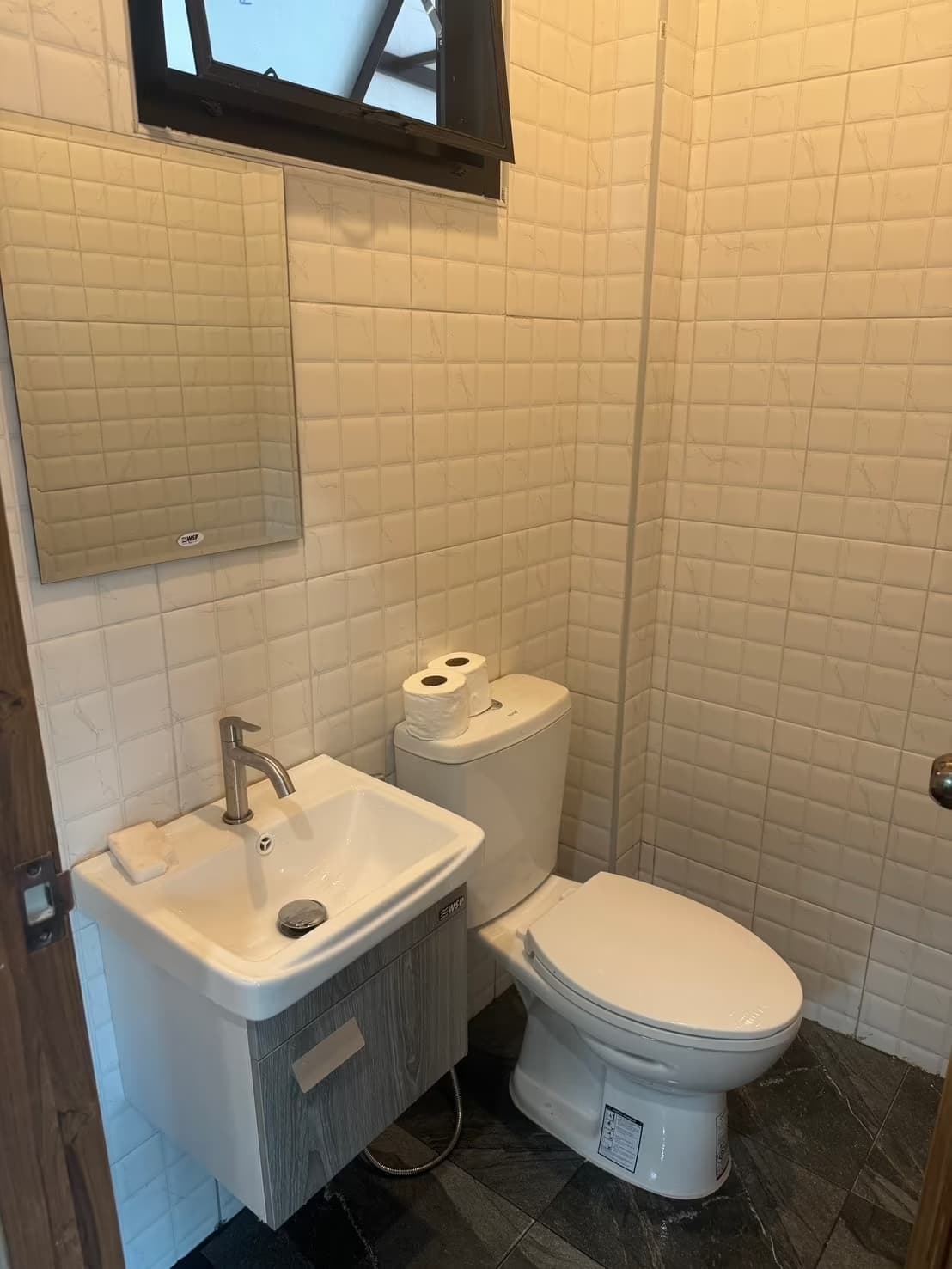 Eden Villa Pai bathroom with vanity sink, mirror and toilet in beige and white tile