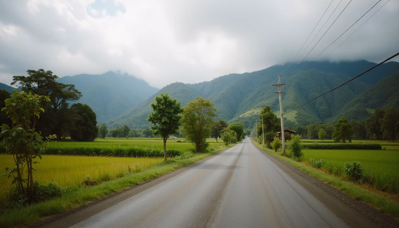 Bright green hills with building clouds, evoking Pai weather in July (illustration)