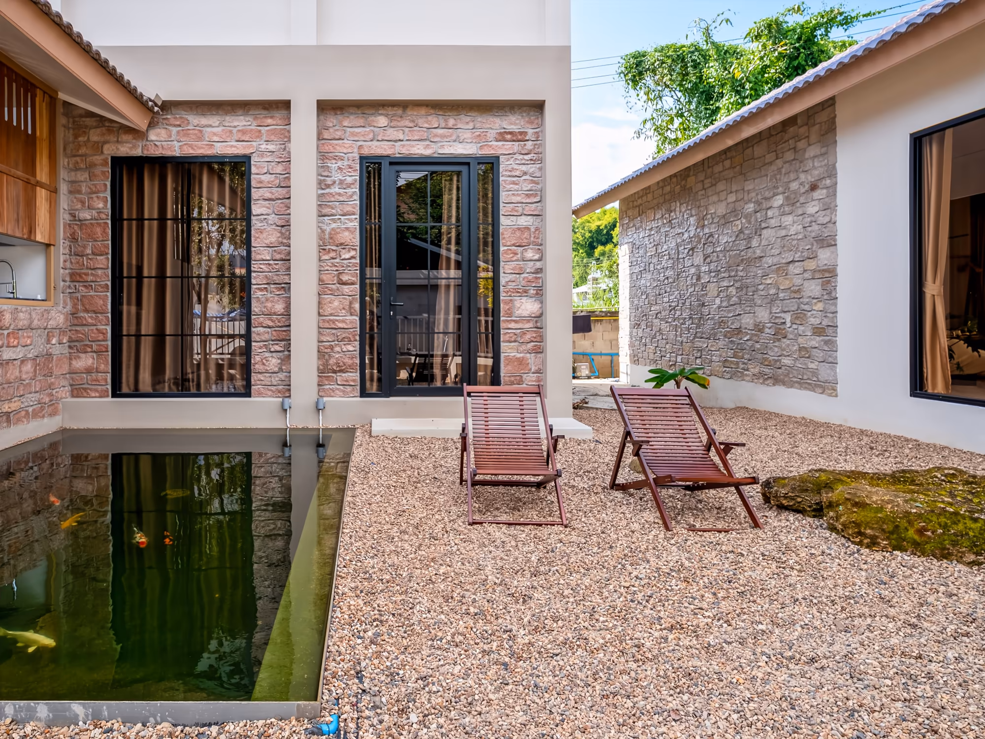 The Arch Casa design hotel Pai stone-clad villa with reflecting plunge pond and lounge chairs