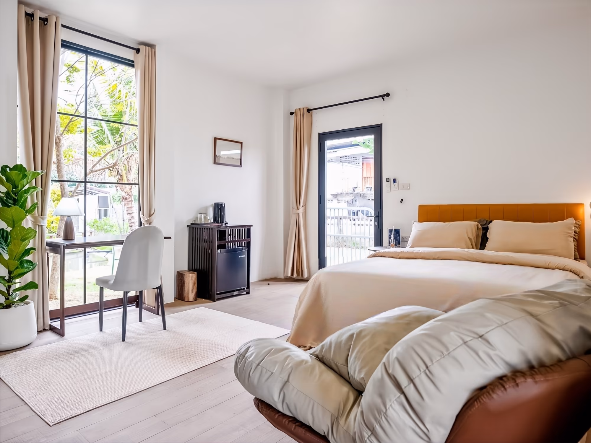 The Arch Casa Pai Suite with Garden View, bright bedroom with floor-to-ceiling windows, leather headboard and garden access