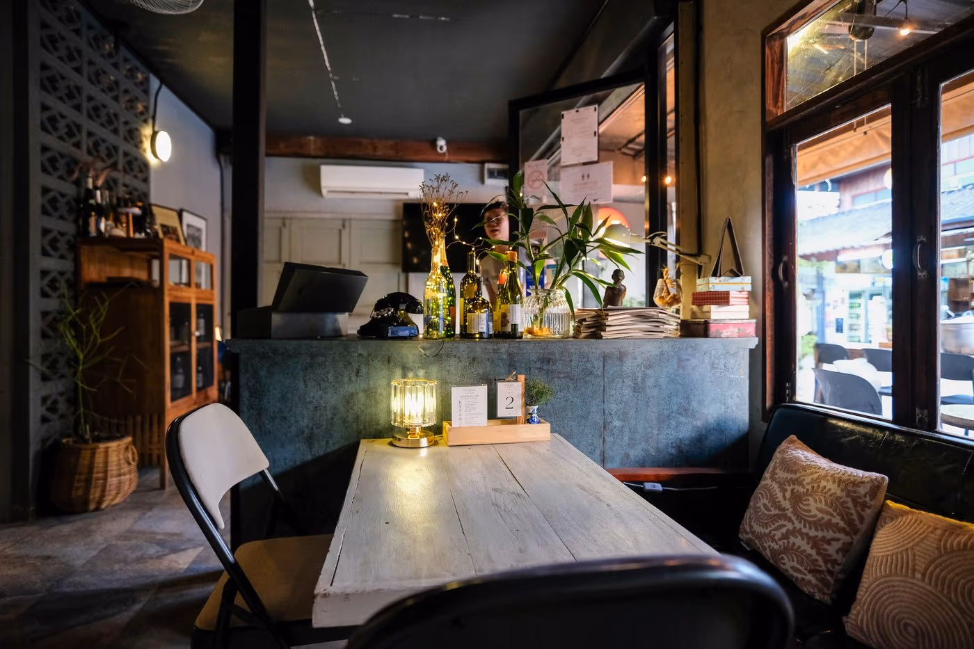 Inside by the window at Vermut Café, Pai — a table with a view of the walking street through the glass