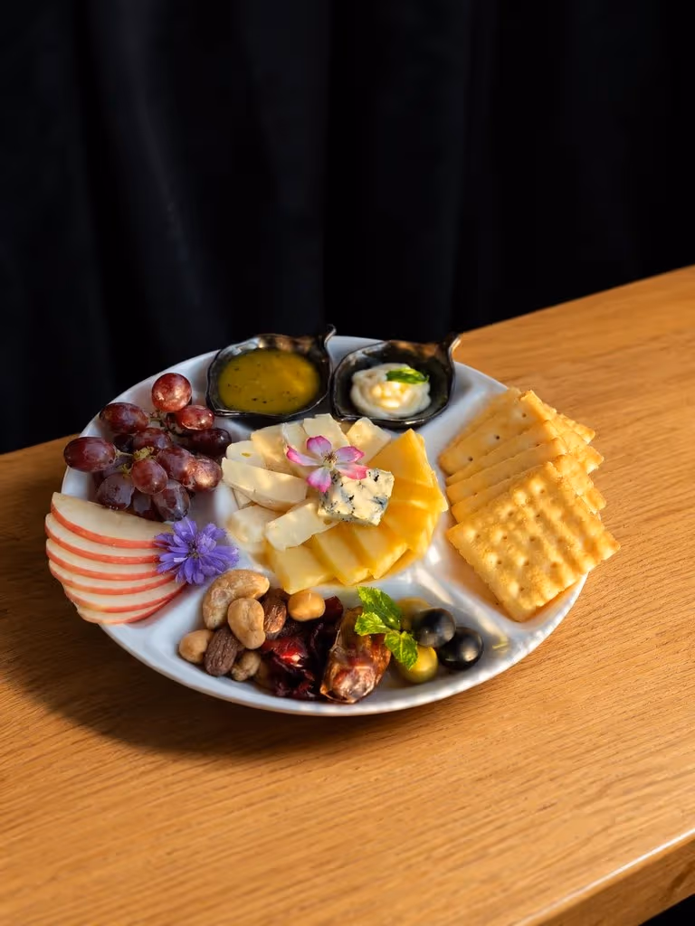 A sharing plate from the kitchen at Vermut Café, Pai — cheese, cold cuts, olives and crackers