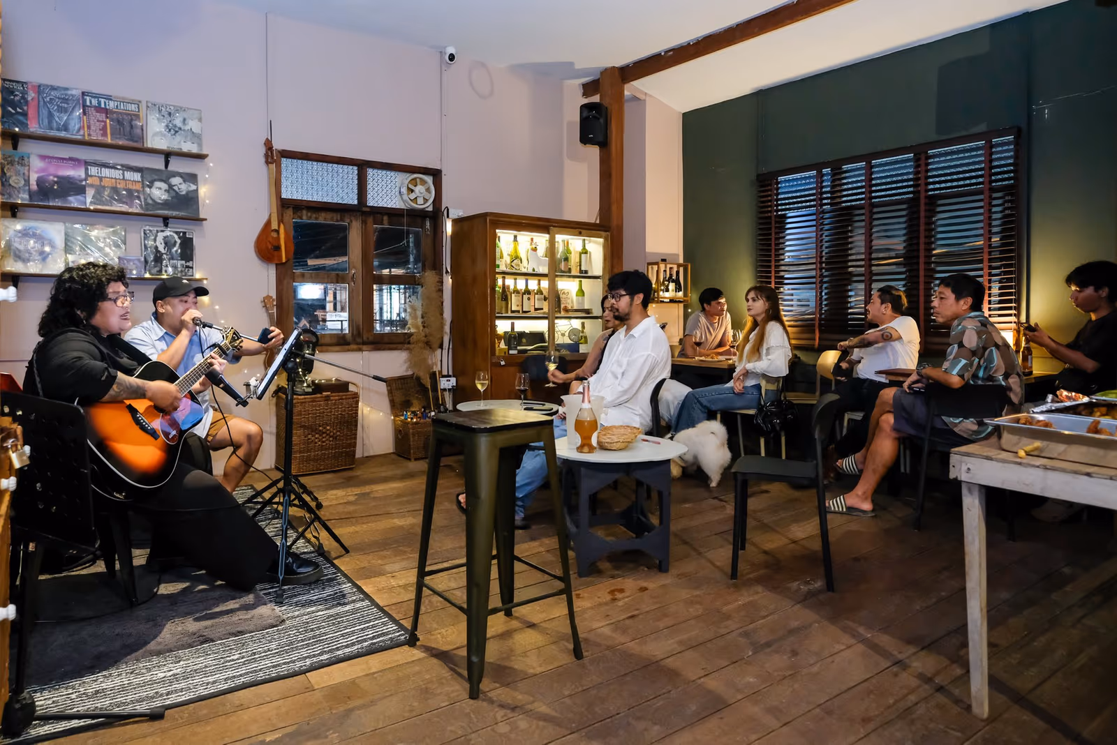 Live music night at Vermut Café, Pai — two musicians with a guitar playing to guests seated upstairs
