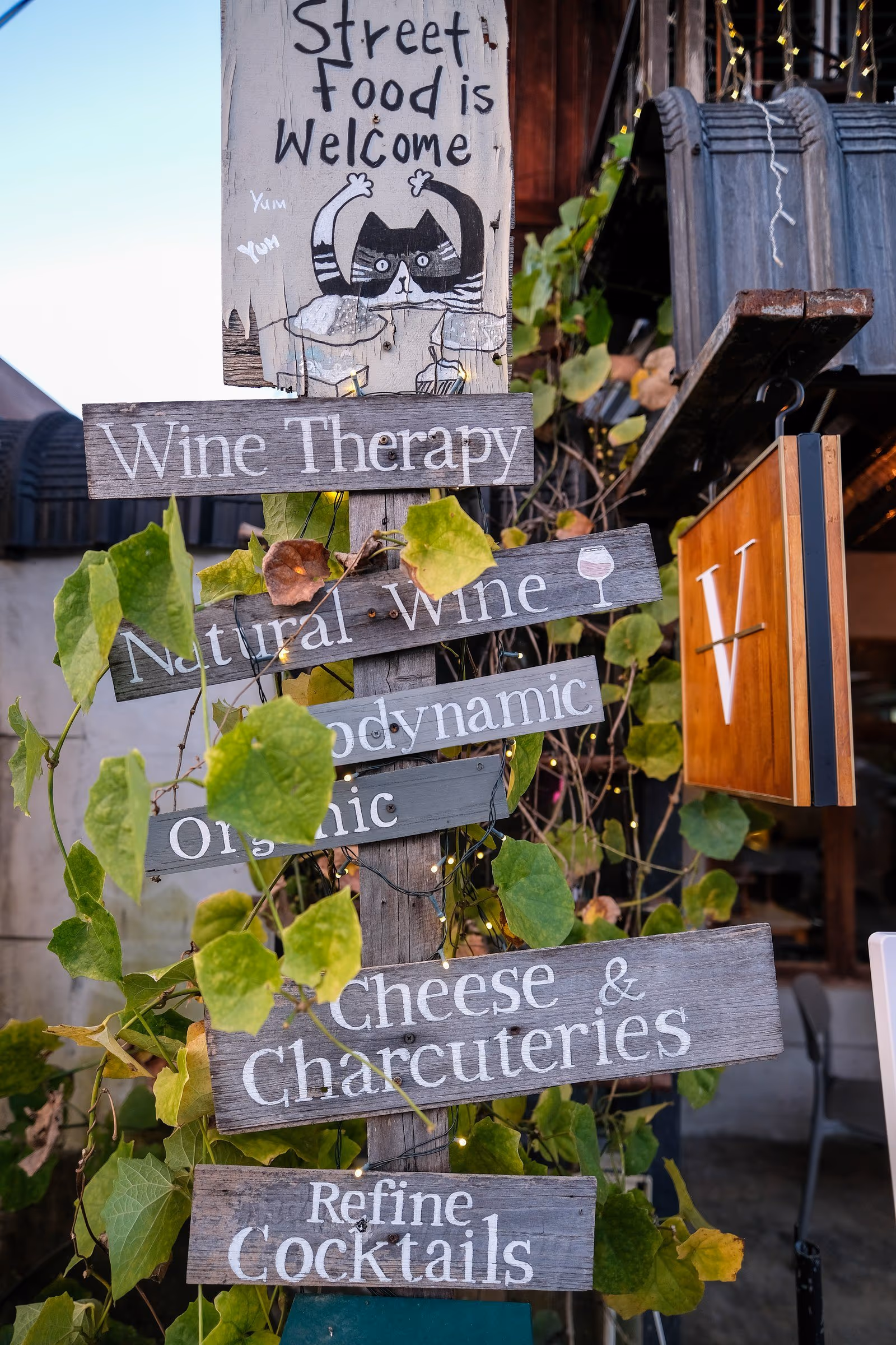 The sign at the door of Vermut Café, Pai: street food is welcome, wine therapy, natural wine, cheese and charcuterie
